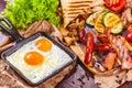 English breakfast with fried eggs, sausages, bacon, vegetables, bread Royalty Free Stock Photo