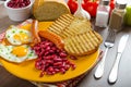 English breakfast - garlic toast, fried egg, beans and English breakfast, toast, egg, beans, sausages Royalty Free Stock Photo