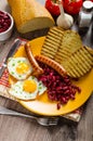 English breakfast - garlic toast, fried egg, beans and English breakfast, toast, egg, beans, sausages Royalty Free Stock Photo