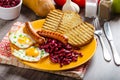 English breakfast - garlic toast, fried egg, beans and English breakfast, toast, egg, beans, sausages Royalty Free Stock Photo