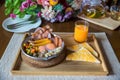 English breakfast in pan with fried eggs, sausages. Panned eggs breakfast set in Thai style street food served on wooden tray with