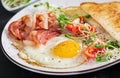 English breakfast - toast, egg, bacon and tomatoes and microgreens salad Royalty Free Stock Photo