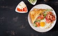 English breakfast - toast, egg, bacon and tomatoes and microgreens salad. Royalty Free Stock Photo