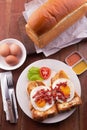 English Breakfast: toast, sunny side up eggs, bacon, ham and salad Royalty Free Stock Photo