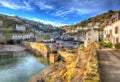 English coast fishing village Polperro Cornwall England with houses and harbour wall in HDR like painting