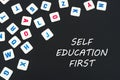 English colored square letters scattered on black background with text self education first