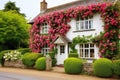 an english cottage-style house with lush rose bushes Royalty Free Stock Photo