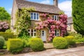 an english cottage-style house with lush rose bushes Royalty Free Stock Photo