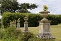 English country garden: Tall marble garden urn and hedge Royalty Free Stock Photo