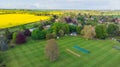 English cricket pitch with colorful trees in a village in the English countryside Royalty Free Stock Photo