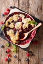 English cuisine: berry cobbler is decorated with mint closeup. Royalty Free Stock Photo