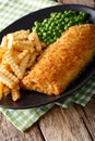 English cuisine: Fish and chips with green peas close-up. vertical Royalty Free Stock Photo