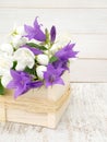 English dogwood and bellflowers bouquet in the wooden box