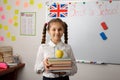 Female pupil with books at classroom Royalty Free Stock Photo