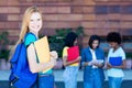 English female student with red hair and group of students Royalty Free Stock Photo