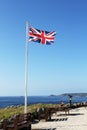 English flag waving on Lands` end. Cornwall, UK Royalty Free Stock Photo