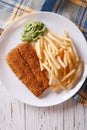 English food: fried fish in batter with chips close-up. vertical Royalty Free Stock Photo