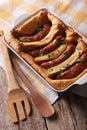 English food: toad in the hole into a baking dish close up. Vert Royalty Free Stock Photo