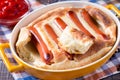 English food: toad in the hole into a baking dish on the table.