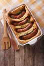 English food: toad in the hole into a baking dish. Vertical top Royalty Free Stock Photo