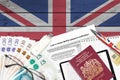 English form LS01 Lost or stolen british passport notification from HM passport office lies on table with office items. UK