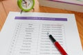 English grammar test sheet on wooden table