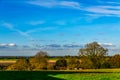 English green meadow on a sunny day, a typical rural landscape o Royalty Free Stock Photo