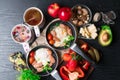 English health breakfast for two. Fried eggs with sausages in a frying pan with spices and fresh vegetables, cheese, nuts Royalty Free Stock Photo
