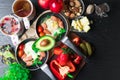 English health breakfast for two. Fried eggs with sausages in a frying pan with spices and fresh vegetables, cheese, nuts Royalty Free Stock Photo