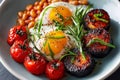 Egg-based breakfast. English hotel breakfast.Â Baked beans, roasted tomatoes and black pudding on a white background. Top view Royalty Free Stock Photo