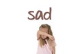 English language learning vocabulary school card with word sad and sweet young little schoolgirl Royalty Free Stock Photo