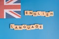 English language lined with letters next to the British flag on blue background Royalty Free Stock Photo