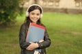 English learning courses. Happy girl learn English. Little child hold English books. Listening comprehension skills