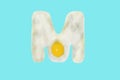 The letter M from a fried egg Royalty Free Stock Photo
