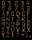 English Letters from sparklers, alphabet and numbers on black background. Royalty Free Stock Photo