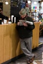 English Market, a municipal food market in the centre of Cork, famous tourist attraction of the city: man reading newspaper.