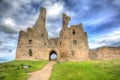 English medieval castle Dunstanburgh Northumberland England uk in hdr Royalty Free Stock Photo