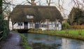 English mill cottage with Thatched roof built over a river Royalty Free Stock Photo