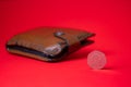 English money - fifty pence on red backdrop. Blurred wallet in the background. Saving money for future Royalty Free Stock Photo