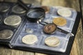 English old coin, magnifier and tweezers, numismatics