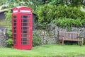 English old red phone booth in a village commons Royalty Free Stock Photo