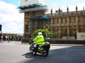 An English policeman on a motorcycle checks and watches over the traffic in central London