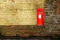 English post box on stone wall in village in england uk Royalty Free Stock Photo