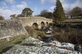 English river with old stone bridge on Dartmoor England UK
