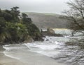 English shoreline with cliffs, castle ruins and sea waves