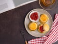 English style scones delicious freshly baked homemade with strawberry jam on a plate and cutlery with a cloth Royalty Free Stock Photo