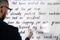 English teacher underlining word on whiteboard at lesson, closeup