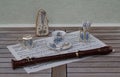 English teacup and saucer, spoon vase, teaspoon and cream jug, metronome for music and a block flute on a sheet of music