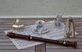 English teacup, spoon vase and teaspoon, sugar bowl and sugar spoon, metronome for music and a block flute on a sheet of music