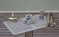 English teacup, spoon vase and teaspoon, sugar bowl and sugar spoon and metronome for music on a sheet of music